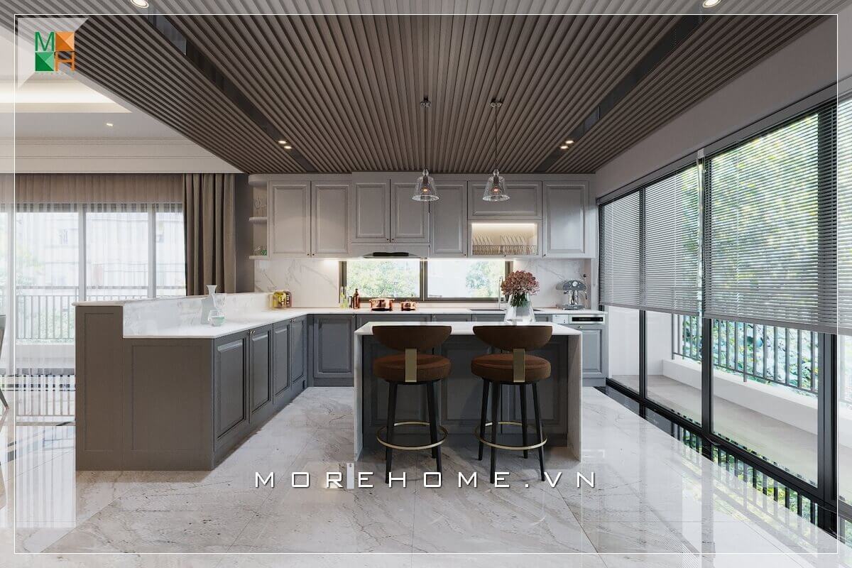 Ấn tượng với mẫu thiết kế phòng bếp không gian mở, với hệ thống tủ bếp và bàn đảo bếp bằng gỗ kết hợp mặt bàn đá nhân tạo cao cấp, lấy ánh sáng từ hệ thống cửa kính ban công cánh trượt, vừa tạo sự thông thoáng cho không gian mà phòng bếp của bạn sẽ luôn khô ráo sạch sẽ nhờ nguồn ánh sáng mặt trời tự nhiên Thiết kế phòng bếp biệt thự